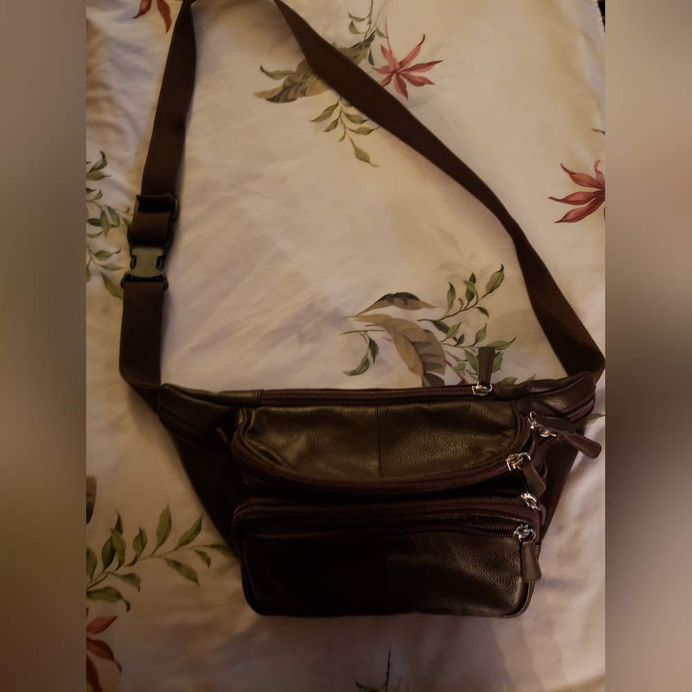 Very nice, brown, leather "fanny pack" type purse. 4 pockets and sturdy strap.